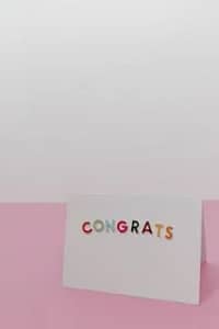 A simple congrats card with colorful letters on a pink background, perfect for celebrations.