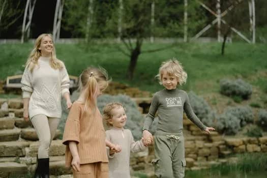 Joyful moment of a family walking together in a vibrant park environment.