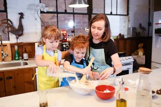 Mother and children baking together, creating memories and enjoying quality family time in a rustic kitchen.